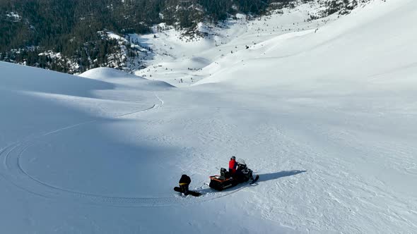 Snowmobile high in the mountains aerial view 4 K