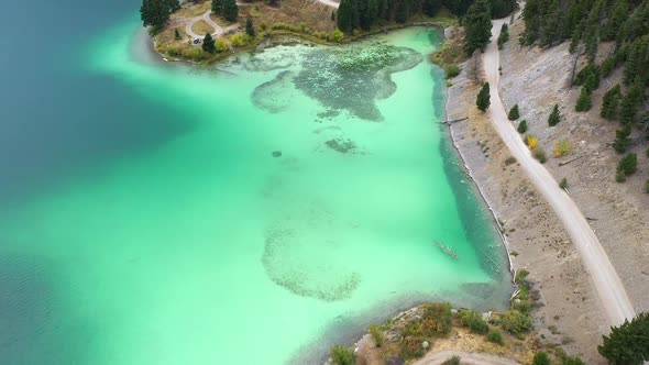 Aerial view of Cliff Lakes colorful water along the shore in Montana