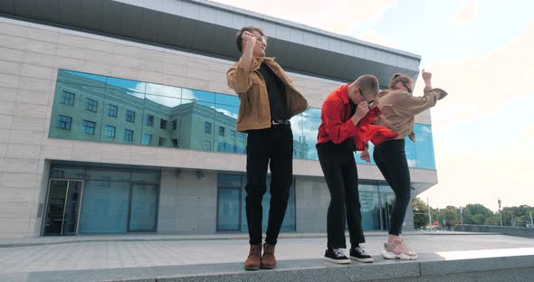 Three Friends Students Engaged in Hobbies Dancing Freestyle Together Enjoying Movement To Music