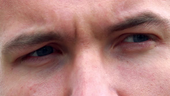 Young Sad Man Looks Around - Detail of Eyes Expression