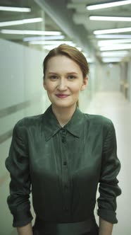 A Young Girl is Standing and Smiling at the Camera