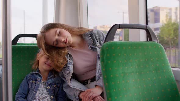 Tired Sleepy Woman with Daughter Fall Asleep in Public Tram Going Home After Hard Working Day