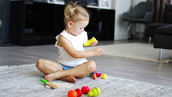 Cute Little Toddler Girl Playing at Home with Eco Wooden Toys