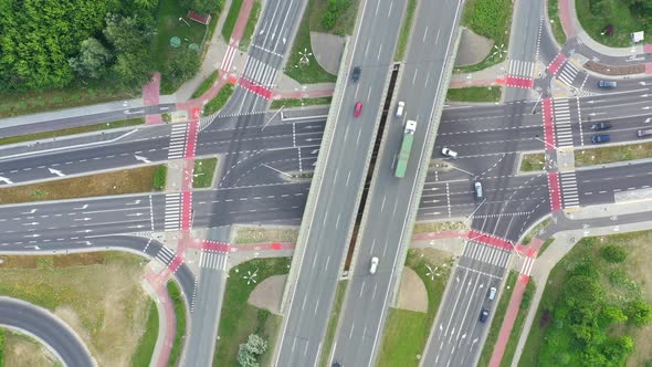 Aerial view over a highway interchange during peak hour traffic.