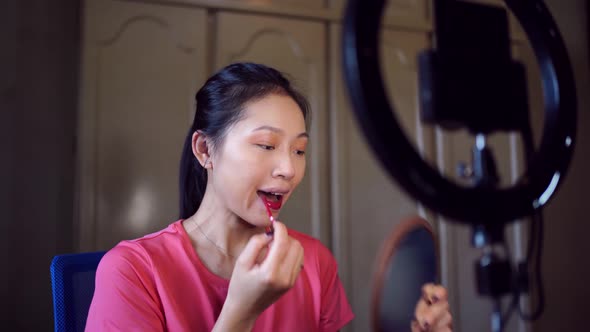 Cheerful female filming beauty video blog