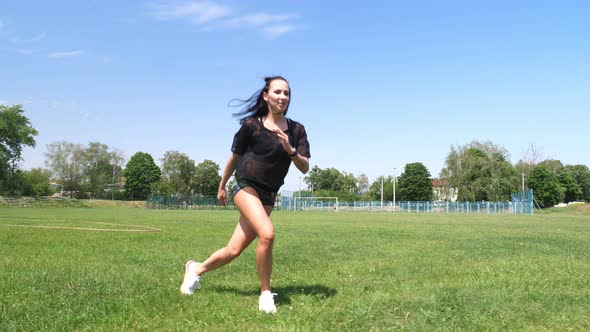 Fitness Woman in Sportswear Doing Various Exercises on Green Grass of Sports Field, at Stadium