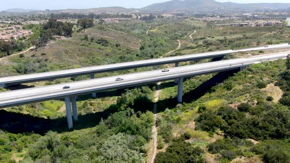 Aerial View of Road Highway Bridge, Viaduct Supports in the Valley Among the Green Hills.