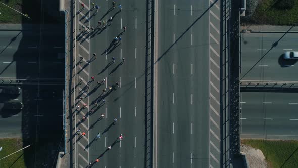 Aerial Drone Footage. Top View Marathon Running on the Road Junction, Close Up Shot