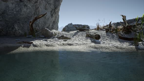 White Sand Beach Near Rocky Cliffs at Ocean alt