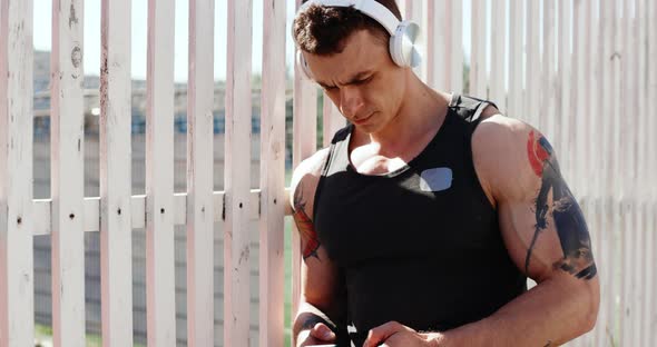 Portrait of Male Athlete Doing Exercises Outdoors in Summer