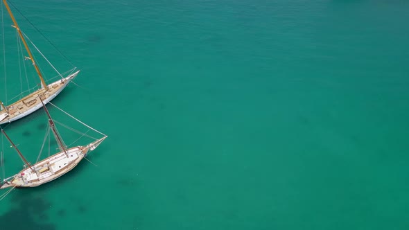 Aerial view of two traditional boats in the mediterranean sea.