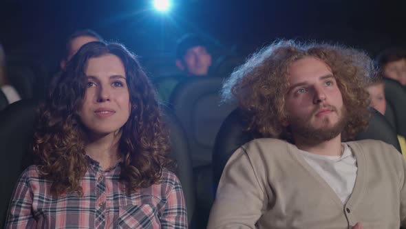 Couple Clapping Hands in Cinema.