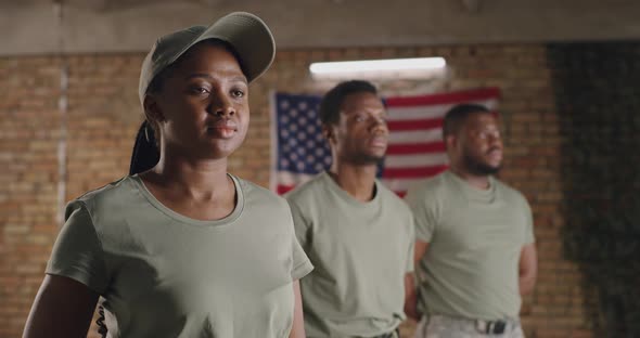 Black Military Woman Standing Near Male Squadmates