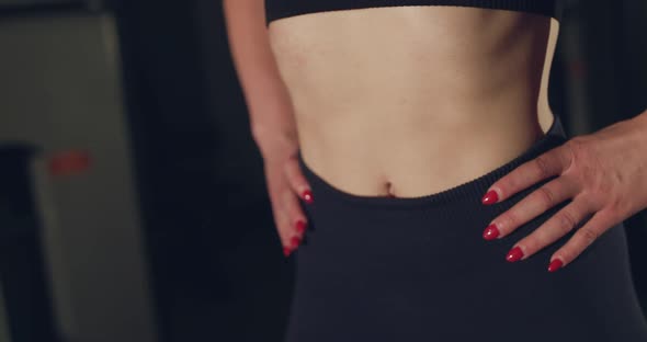 Close View of Female Slim Waist with Press During Warming Up in a Gym