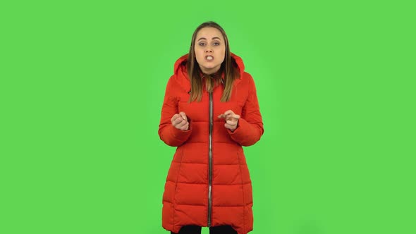 Lovely Girl in a Red Down Jacket Annoyed Gesturing in Stress Expressing Irritation and Anger. Green