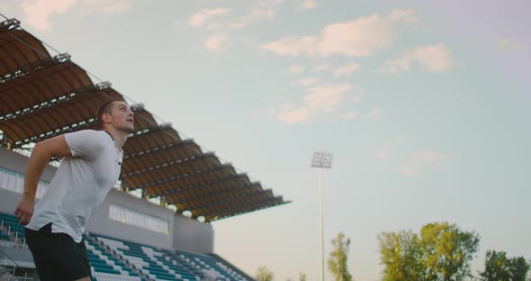 Slow-motion, Professional Soccer Player Heading the Ball in Gear at the Stadium. Soccer Football