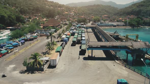 Aerial View of Island Harbor Port with Many Trucks