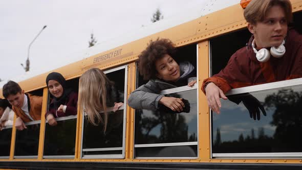 Students with Heads Out of School Bus Windows