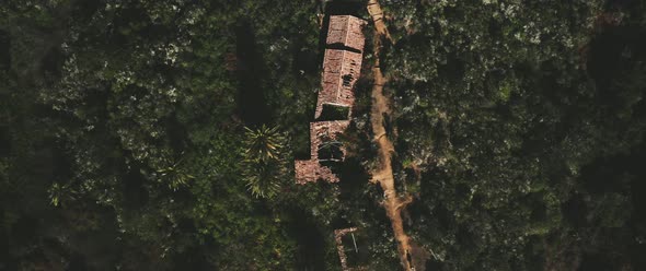 Man walking on the road near abandoned home