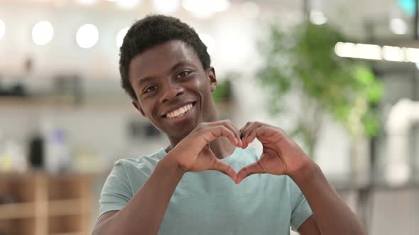 Young African Man Showing Heart Sign with Hand