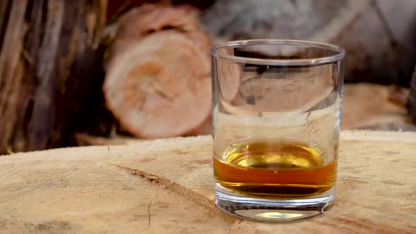 Canadian Club 1858 whiskey mixed with coke ice splash with wood background, 1920x1080 25fps