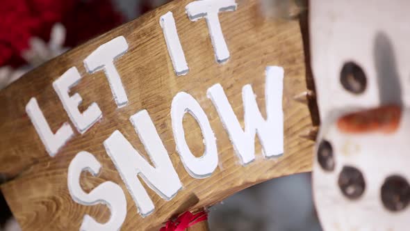 Panning view of Let It Snow sign