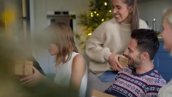 Woman receiving sweater as Christmas present. Shot with RED helium camera in 8K