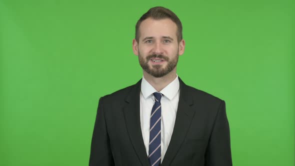 Businessman Having Talk and Waving Hand Against Chroma Key