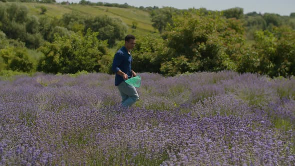 Man Collecting Butterflies with Net in Feild