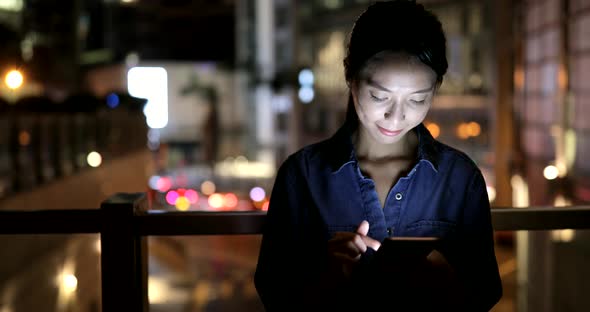 Woman using smart phone in city 