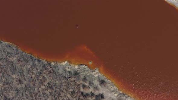 Red acidic water laden with iron sulfate  and other metals 4K aerial video