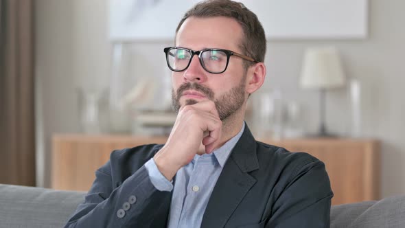 Portrait of Pensive Young Businessman Thinking of New Idea 