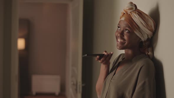 African American Woman Recording Voice Message on Cellphone