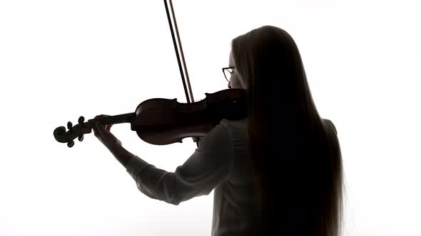 Woman with Glasses Plays the Violin with Bow a Black Silhouette on White Background