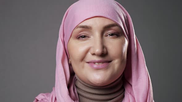 Woman Wearing Hijab Smiles Widely Looking Into Camera