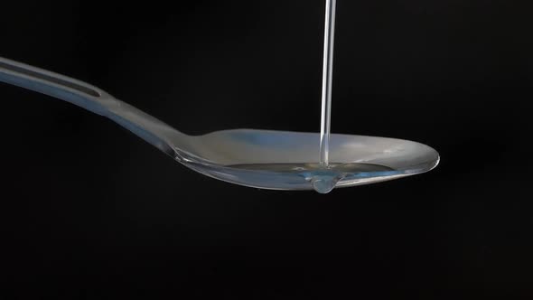 Oil Pouring On Spoon