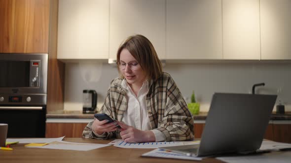 Young Woman is Working at Home