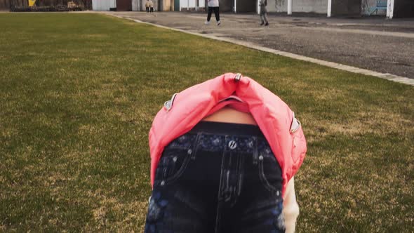 Active Little Girl Doing Backbend on Green Grass