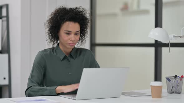 Successful African Woman Celebrating on Laptop