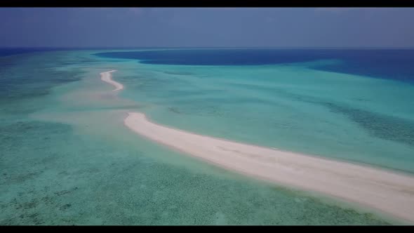 Aerial view scenery of exotic island beach voyage by blue ocean with white sandy background of a day