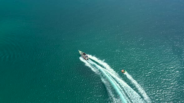 Aerial drone photo of extreme powerboat donut water-sports cruising in high speed in tropical turquo