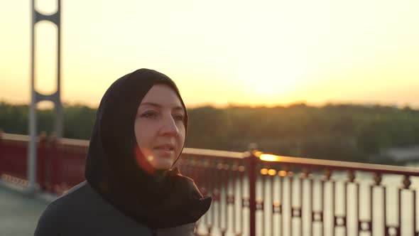Sporty Muslim Female in Hijab Jogging on Bridge