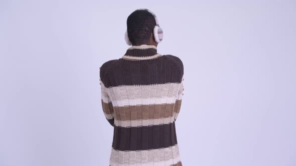 Rear View of Young African Man Waiting and Thinking Ready for Winter