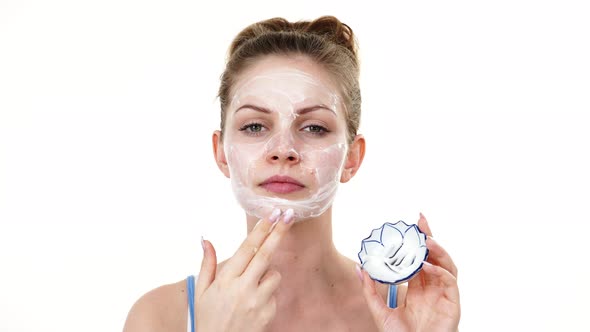 Woman Applying Mask Cream on Face