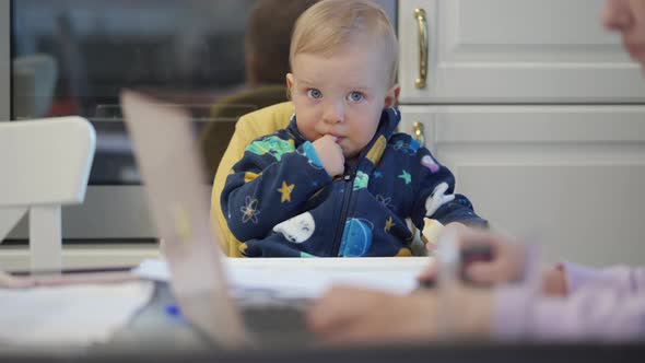 Woman with Baby Working with Laptop