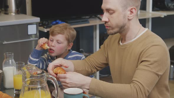Same-Sex Couple with Kid Eating Breakfast