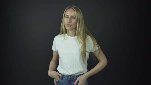 Lady with Long Loose Fair Hair Poses with Hands on Jeans