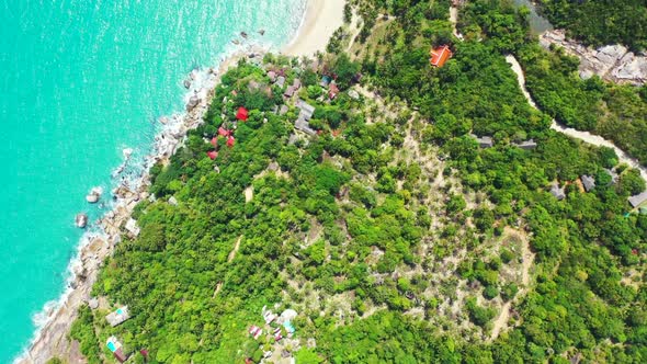 Aerial flying over nature of idyllic resort beach voyage by aqua blue ocean and white sand backgroun