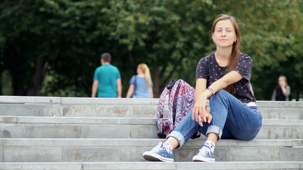 Woman sit on the stairs outside