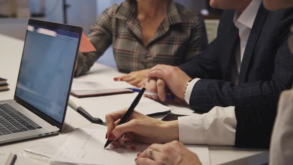 Workers Making Notes and Talking About Innovation in New Startup